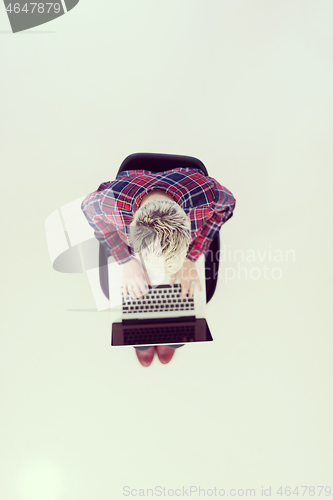 Image of top view of young business woman working on laptop computer