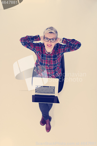 Image of top view of young business woman working on laptop computer