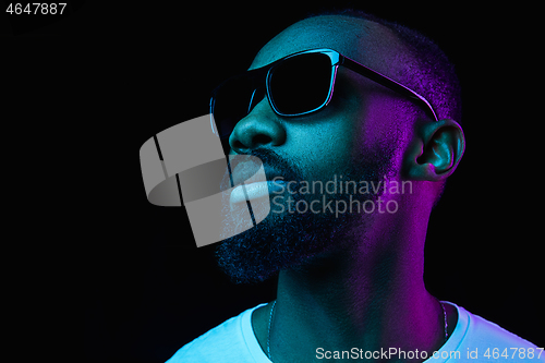 Image of The neon portrait of a young smiling african man