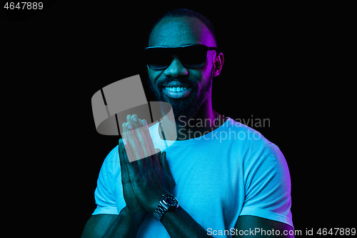 Image of The neon portrait of a young smiling african man