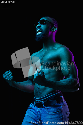 Image of Close up portrait of a young naked african man indoors