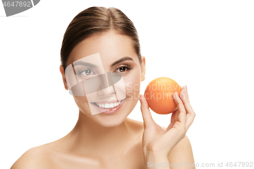 Image of portrait of attractive caucasian smiling woman isolated on white studio shot eating green apple