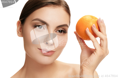 Image of portrait of attractive caucasian smiling woman isolated on white studio shot eating green apple