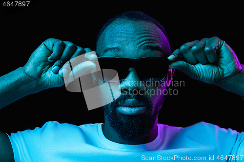 Image of The neon portrait of a young smiling african man