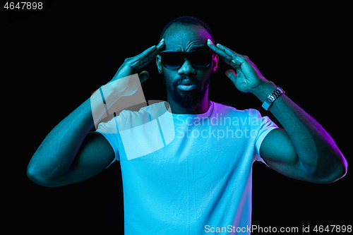 Image of The neon portrait of a young smiling african man