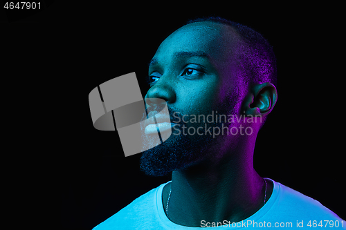 Image of The neon portrait of a young smiling african man