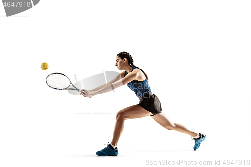 Image of Full length portrait of young woman playing tennis isolated on white background