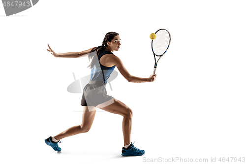 Image of Full length portrait of young woman playing tennis isolated on white background