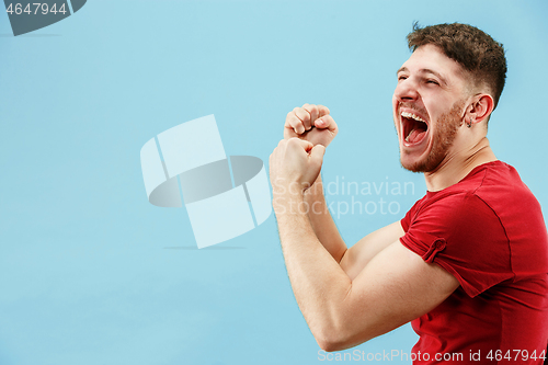 Image of Winning success man happy ecstatic celebrating being a winner. Dynamic energetic image of male model