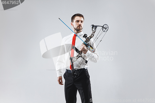 Image of Businessman aiming at target with bow and arrow, isolated on white background