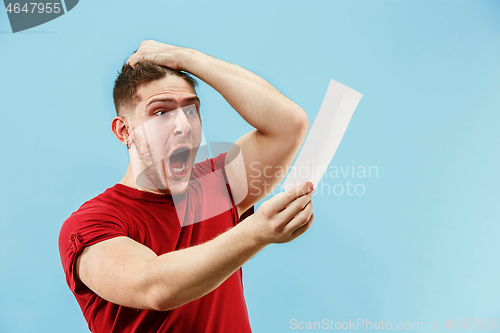 Image of Young boy with a surprised expression bet slip on blue background