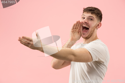 Image of Isolated on pink young casual man shouting at studio