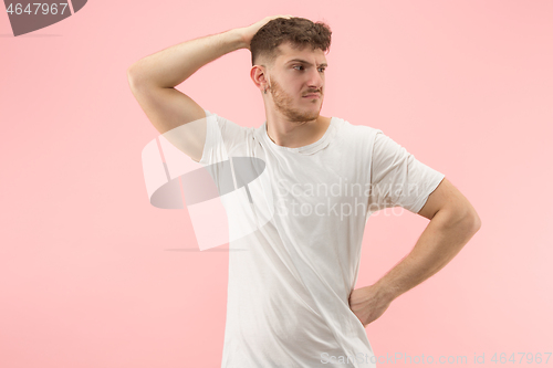 Image of Beautiful man looking suprised and bewildered isolated on pink