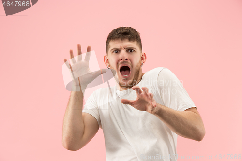 Image of Portrait of the scared man on pink