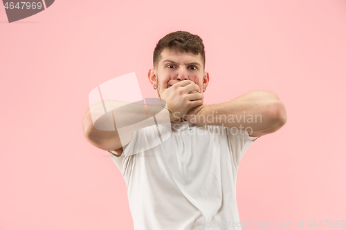 Image of Beautiful man looking suprised and bewildered isolated on pink