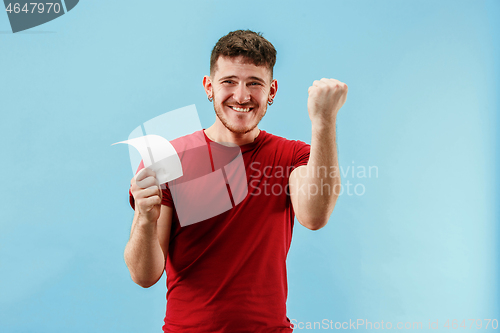 Image of Young boy with a surprised expression bet slip on blue background