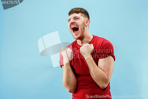 Image of Winning success man happy ecstatic celebrating being a winner. Dynamic energetic image of male model