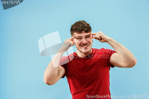 Image of Young boy with a surprised expression bet slip on blue background