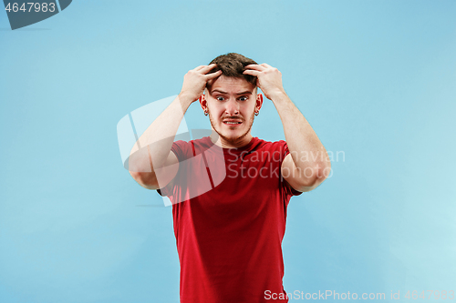 Image of Young boy with a surprised expression bet slip on blue background