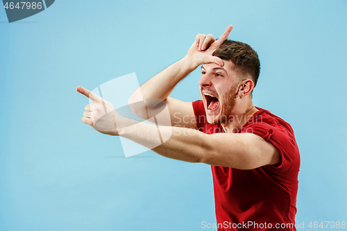 Image of Winning success man happy ecstatic celebrating being a winner. Dynamic energetic image of male model