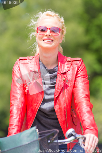 Image of Young woman riding a bicycle.