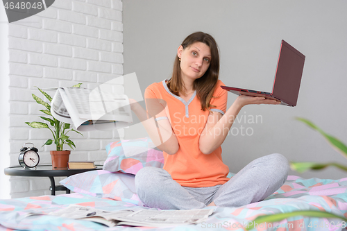 Image of The girl could not find a job either with the help of a newspaper or with the help of a laptop on the Internet