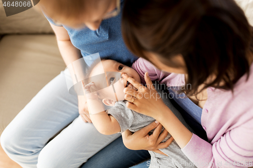 Image of happy mixed-race family with baby son at home