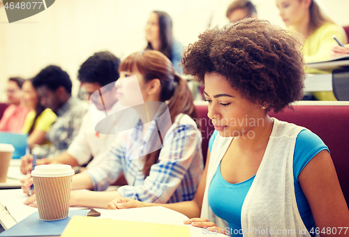 Image of group of students with coffee writing on lecture