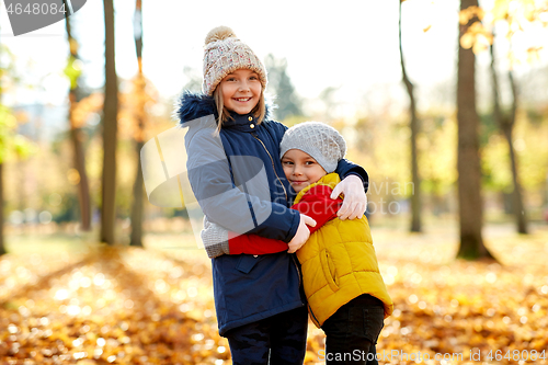 Image of happy children hugging at autumn park