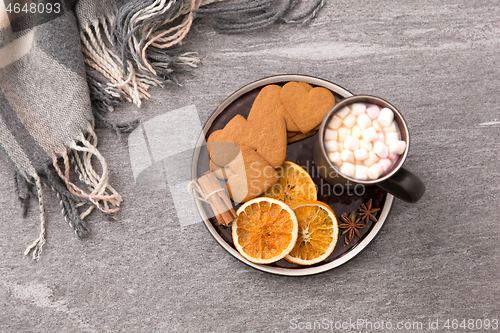 Image of hot chocolate with dried orange, cookies and anise