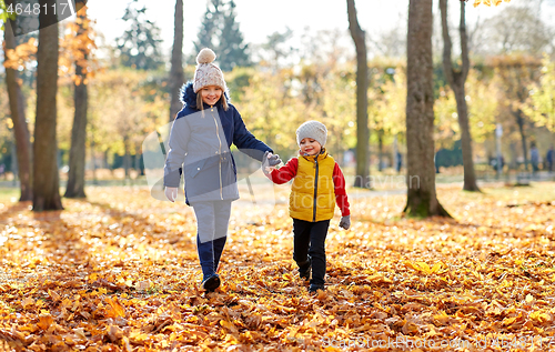 Image of happy children walking at autumn park