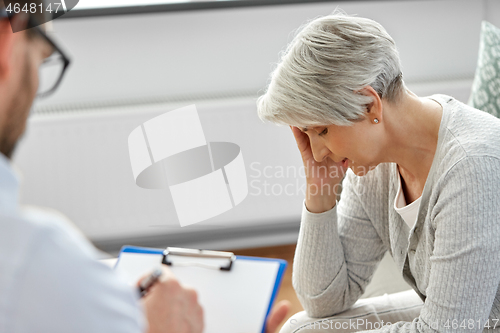 Image of sad senior woman patient and psychologist