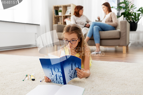 Image of student girl with textbook learning at home