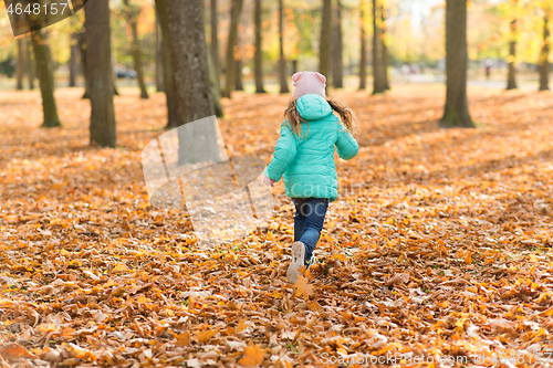 Image of happy girl running in autumn park