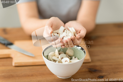 Image of close up of woman holding chopped champignons