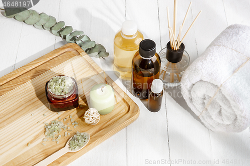 Image of Beautiful spa composition on massage table in wellness center, copyspace, leaves\' shadow