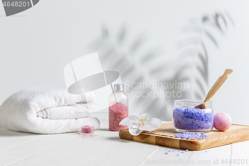 Image of Beautiful spa composition on massage table in wellness center, copyspace, leaves\' shadow