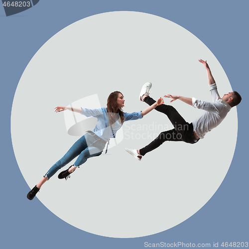 Image of Mid-air beauty. Full length studio shot of attractive young woman and man hovering in air and keeping eyes closed