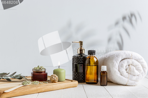 Image of Beautiful spa composition on massage table in wellness center, copyspace, leaves\' shadow