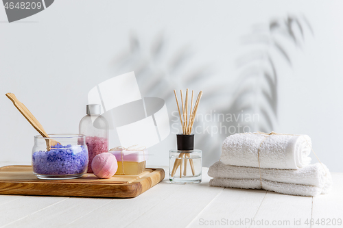 Image of Beautiful spa composition on massage table in wellness center, copyspace, leaves\' shadow