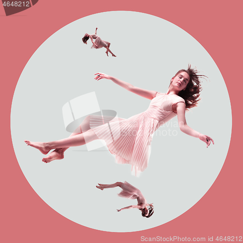 Image of Mid-air beauty. Full length studio shot of attractive young woman hovering in air and keeping eyes closed