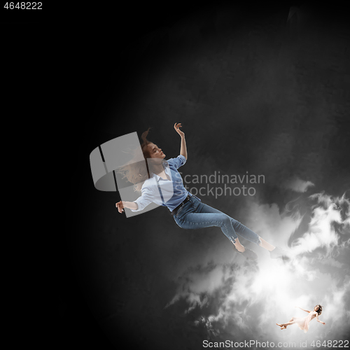 Image of Mid-air beauty. Full length studio shot of attractive young woman hovering in air and keeping eyes closed