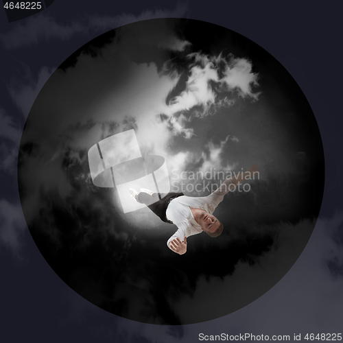 Image of Mid-air beauty. Full length studio shot of attractive young man hovering in air and keeping eyes closed