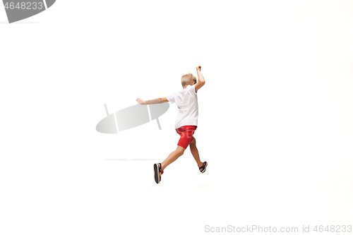 Image of Happy little caucasian boy jumping and running isolated on white background