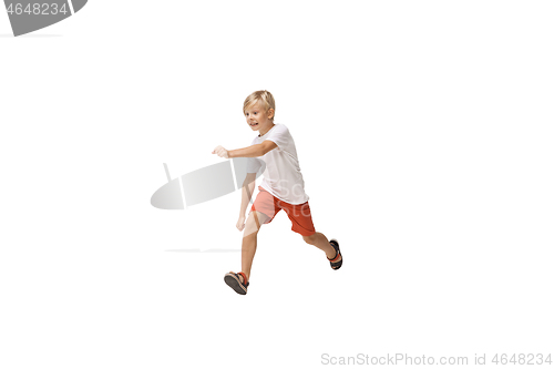 Image of Happy little caucasian boy jumping and running isolated on white background