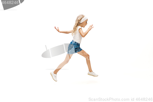 Image of Happy little caucasian girl jumping and running isolated on white background