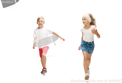 Image of Happy little caucasian girl and boy jumping and running isolated on white background