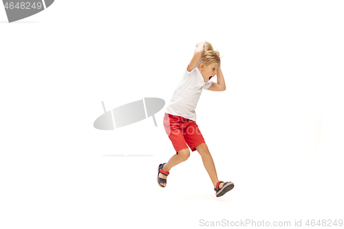 Image of Happy little caucasian boy jumping and running isolated on white background