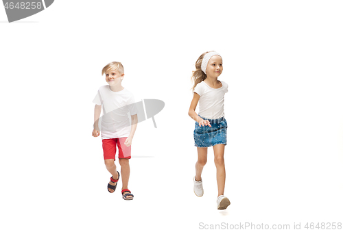 Image of Happy little caucasian girl and boy jumping and running isolated on white background