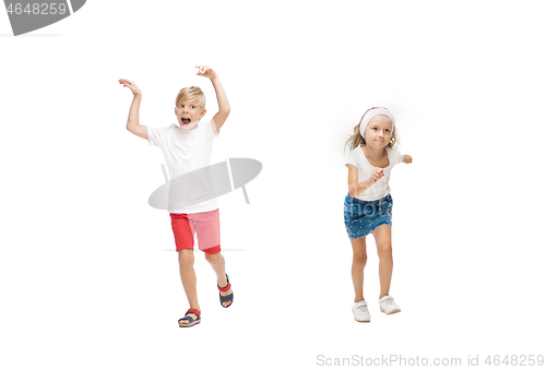 Image of Happy little caucasian girl and boy jumping and running isolated on white background